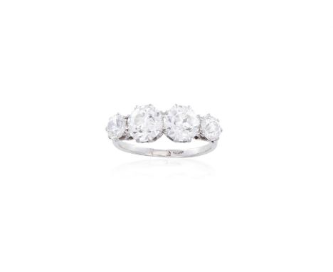 A DIAMOND FOUR-STONE RINGSet centrally with two transitional brilliant-cut diamonds, each weighing approximately 1.10cts, bet