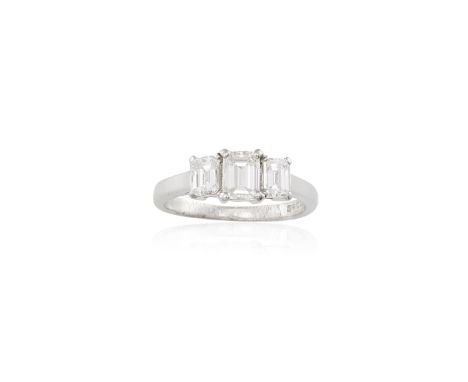A DIAMOND THREE-STONE RINGThe central rectangular-cut diamond weighing approximatley 0.60ct, within two similarly-cut diamond