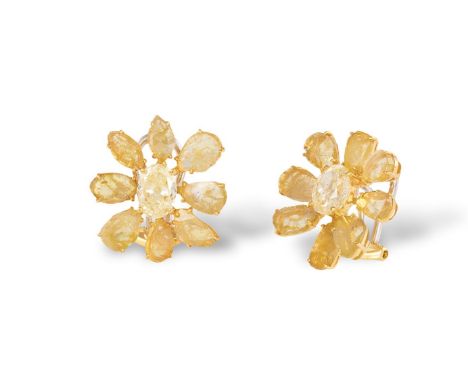 A PAIR OF COLOURED DIAMOND EARRINGSEach designed as a flowerhead, the central oval-shaped yellow diamond, within a surround o