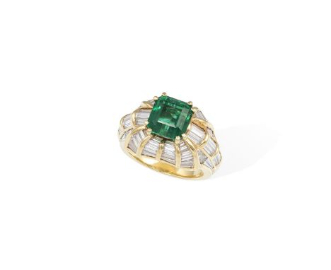 AN EMERALD AND DIAMOND DRESS RINGOf bombé form, centring a rectangular-cut emerald weighing 3.24cts, within a double four-cla