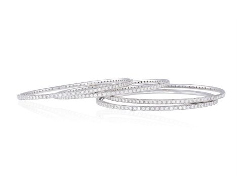 A SET OF FOUR DIAMOND BANGLESEach bangle set with a continuous line of round brilliant-cut diamonds, mounted in 18K gold, dia