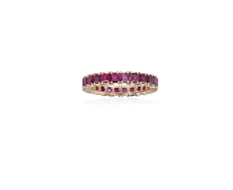 A RUBY ETERNITY RINGComposed of a continuous row of square-cut rubies, each within a four-claw setting, mounted in 18K gold, 