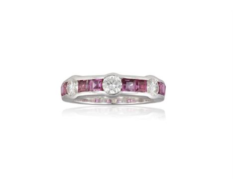 A RUBY AND DIAMOND RING, BY WEMPEThe trio of round brilliant-cut diamonds, between channel-set calibré-cut rubies, mounted in