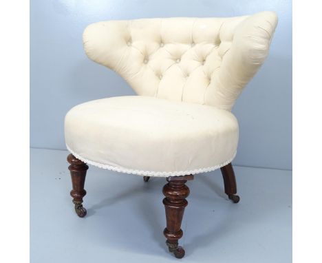 A Victorian button back upholstered bow arm parlour chair with mahogany show wood. 