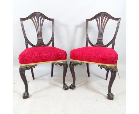 A pair of antique Chippendale-style ebonised and upholstered dining chairs, with shield backs, raised on cabriole legs with c