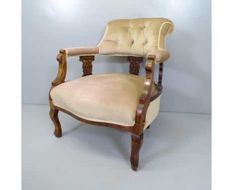 A Victorian mahogany and button-back upholstered bow arm lounge chair. 