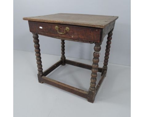 An 18th century oak side table with single drawer, raised on bobbin turned legs with all around stretcher. 66x66x52cm 