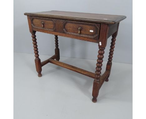 An antique stained oak side table, with single frieze drawer and raised on bobbin turned legs. 88x74x45cm. 