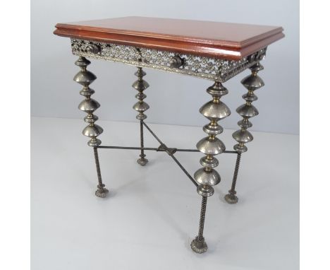 An unusual design side or lamp table, with the mahogany top on ornate base with beaten metal bobbin legs. 65x74x42cm WITH THE