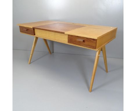 A mid-century style teak veneered dressing table/desk, with rising top revealing a mirror, two fitted drawers and raised on c