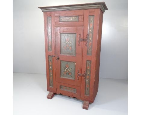 An 18th century continental folk art painted marriage armoire, with single panelled door and shelf-fitted interior. 110x168x5