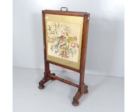 An Antique William IV mahogany-framed firescreen, with needlework upholstered panel. 62x100x35cmmax height of 158 with lift u
