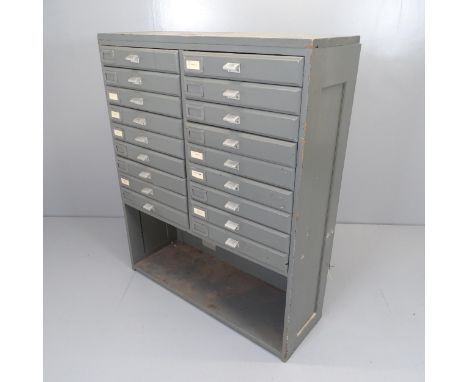 A vintage painted pine bank of 18 fall-front drawers with shelf under. 93x114x35cm 