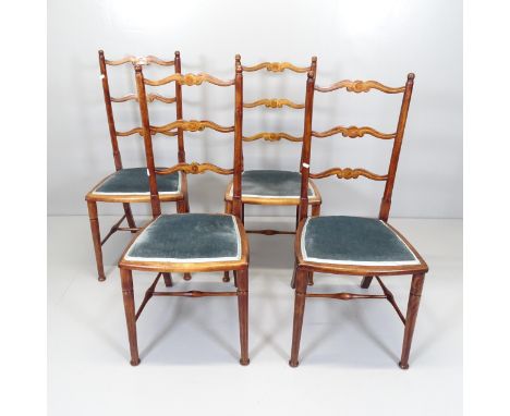 A set of four antique mahogany and satinwood strung Chippendale style ladder back dining chairsLoose in the joints. Some abra