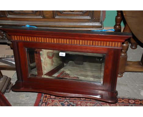 An ornate Edwardian Mahogany framed small Overmantle Mirror having moulded cornice to the top over a striped veneered frieze,