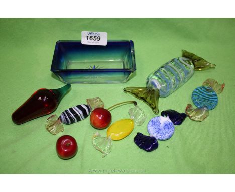 A quantity of decorative glass items including blue glass trinket box, cherries, red glass stopper, Murano glass sweets.