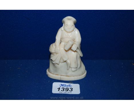 A signed Chinese Ivory carving of a figure holding a hammer seated on a rock, circa 1900