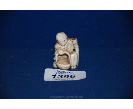 A small Japanese Ivory Netsuke having natural Himotoshi (using the handle of the basket), dating from early Meiji period