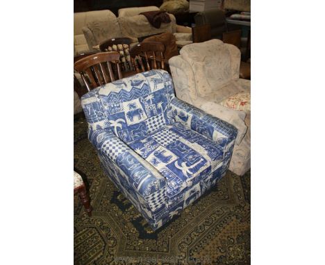 A modern Fireside Armchair of square form, upholstered with blue and cream abstract print fabric.