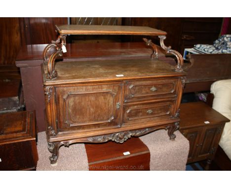 A circa 1920 Walnut French Cabinet having upper cross-banded moulded edge shelf on scroll carved supports, the base having  m