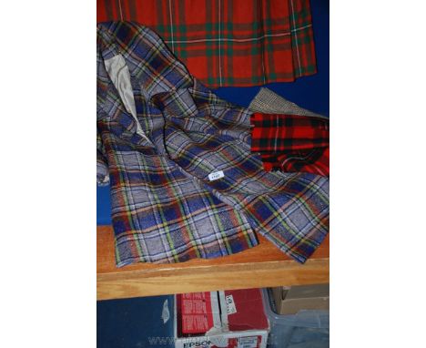 A short red tartan Kilt by the Scotch House, Knightsbridge, London one other long Kilt by Fine Woollens, Scotland, a hand mad