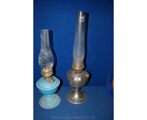 An Aladdin oil Lamp with chimney together with a blue painted Oil Lamp also with chimney.