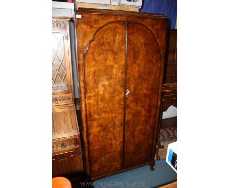 A double door Walnut Wardrobe by Palatial Furniture, with moulded cornice over a pair of well figured single shaped panel Bur