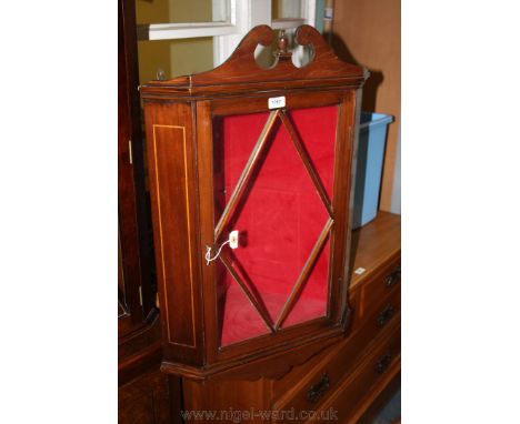 An elegant Edwardian Wall hanging Corner Cabinet having swan pediment top with central finial over the single, five pane glaz