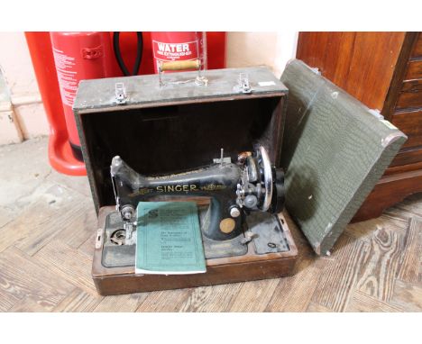 A vintage Singer sewing machine in case