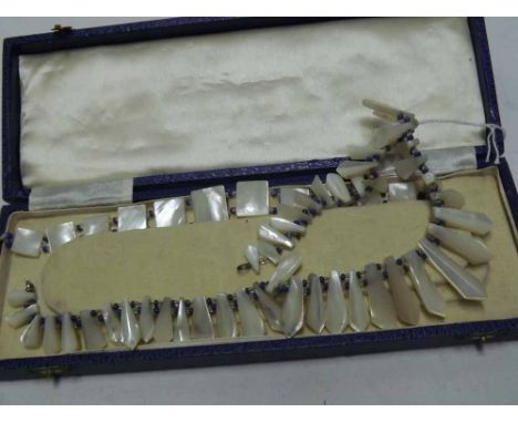 A Vintage Mother-of-Pearl Fringe Necklace with blue and white stone bead dividers, together with a matching Bracelet (2) 
