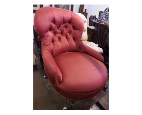 Small Victorian red upholstered armchair, the back with buttoned detail over a bow front seat, raised on short turned legs wi