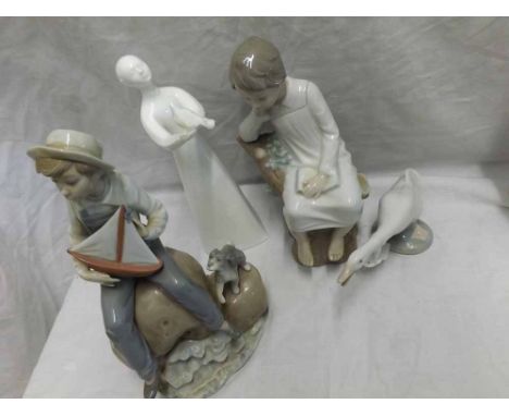 Three Lladro figures comprising a group of a young boy and a puppy with a sailing boat, a further seated child with a book, a