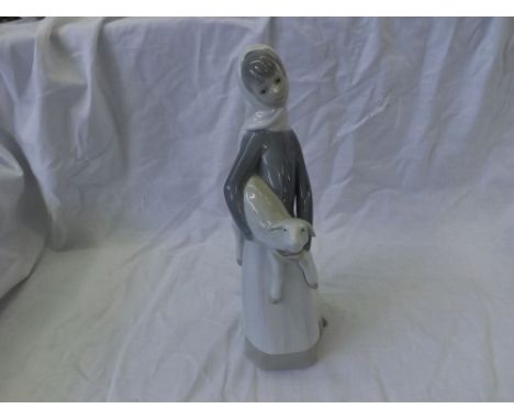 Lladro figure of a girl with a lamb under her arm, decorated in typical colours, 11" high