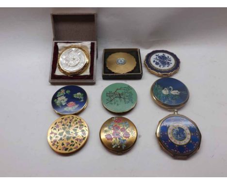 A collection of nine mostly Stratton Powder Compacts, each in gilt tone metal with decorative enamel covers  