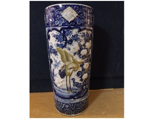A Chinese Stick Stand of cylindrical form, relief decorated with exotic birds and foliage and with panels of scenes on a grou