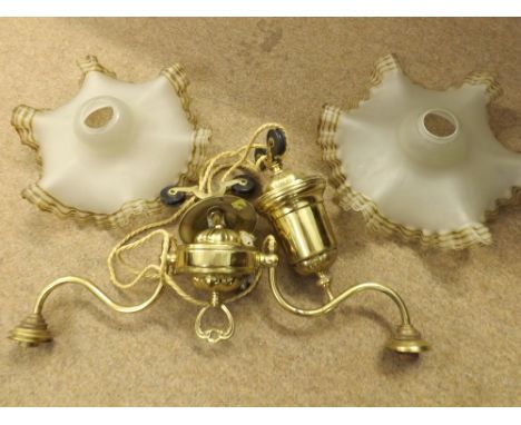Brass rise and fall centre ceiling light fitting with two branches and accompanying frilled opaque glass shade, fitting appro