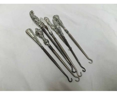 Mixed lot of seven Steel and Silver handled button hooks to include examples with foliate decorated handles, largest 9" long,