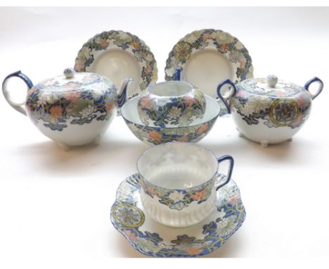 An Oriental Eggshell Tea Service, the borders all painted in iron red, underglaze blue etc with foliage, and with blue rims a