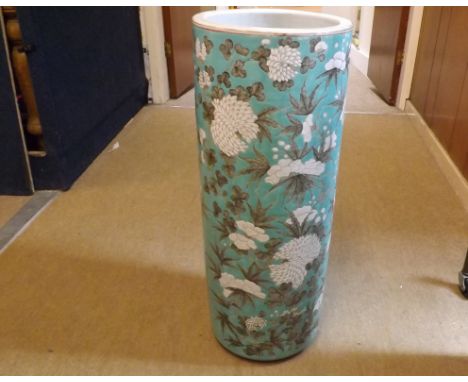 A Chinese cylindrical Stick Stand, painted in grey and white with all over flowering foliage on a turquoise ground (rim with 