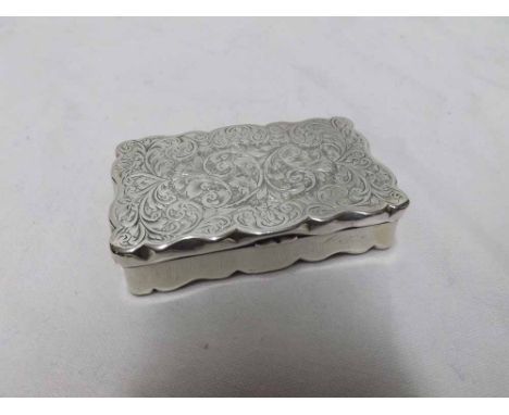 Late Victorian Silver snuff box of rectangular form, the lid and base decorated with scrolled floral detail opening to a gilt