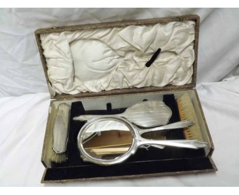 Cased Silver backed six-piece Dressing Table set, decorated with engine turned detail comprising hand mirror, comb and four b