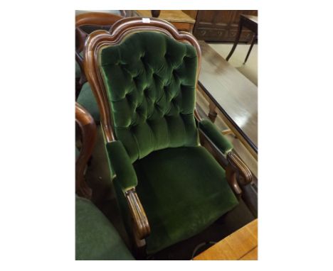 A Victorian Mahogany Gents Armchair, with swept back joined by arms terminating in scrolls and upholstered throughout in gree