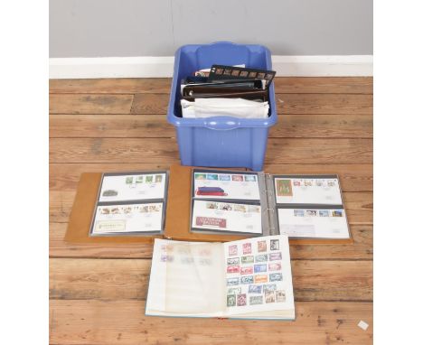 A quantity of stamps and approximately 100 first day covers, together with several blank albums and stamp guides.  