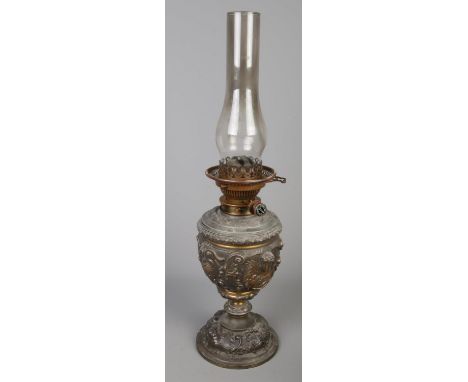 An ornate cast metal oil lamp. Decorated with figures. (56cm)  