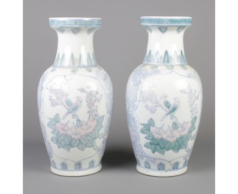 A large pair of oriental ceramic vases with transfer print decoration. 47cm high.  