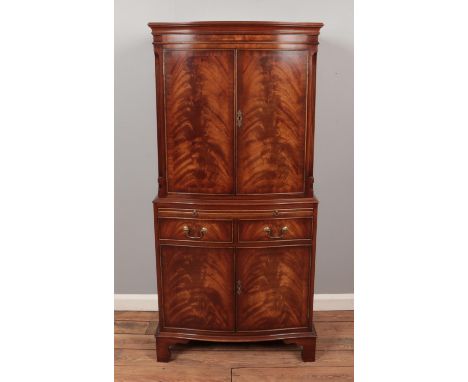 A Reprodux mahogany bow-fronted drinks cabinet, with two sets of drawers pull out tray and interior light (not tested). Heigh