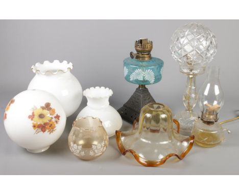 A box of oil lamp parts. Including glass shades, fonts, etc.  