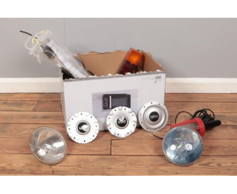A box of miscellaneous. To include a Lucas spot light, Mini Cooper centre caps, inspection lamp etc  
