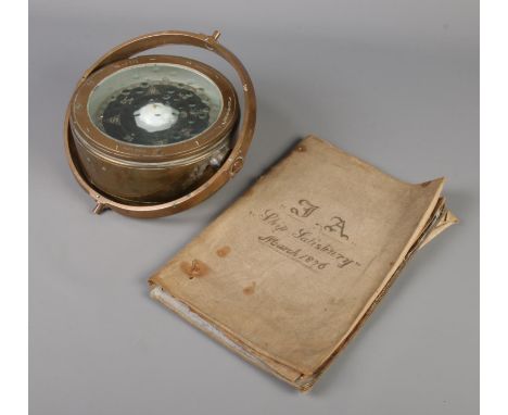 A nautical brass gimbal/compass along with an 1876 ships log book for Ship Salisbury.  