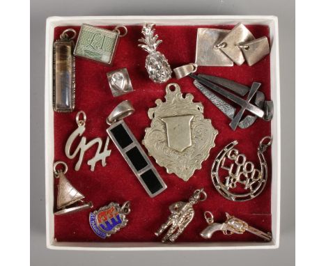 A collection of silver and white metal charms, to include enamel, Â£1 note and ship examples.  